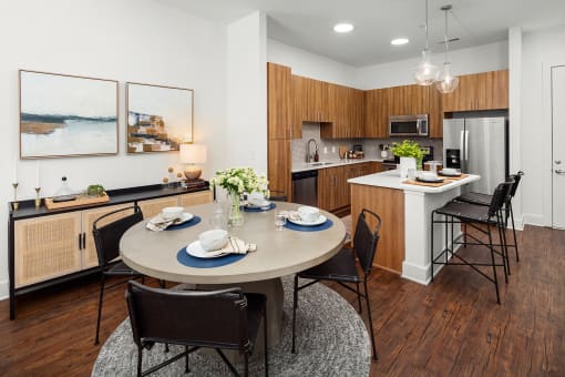 a dining room and kitchen with a table and chairs