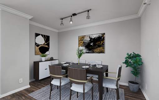 A dining room with a table set for four.