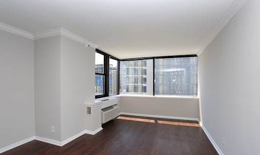 A room with a window seat and a radiator.