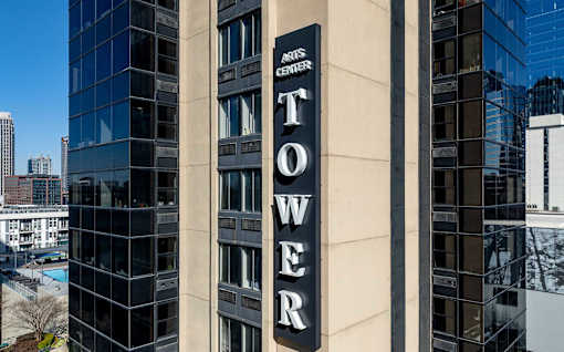 A tall building with a sign that says "Tower Center".