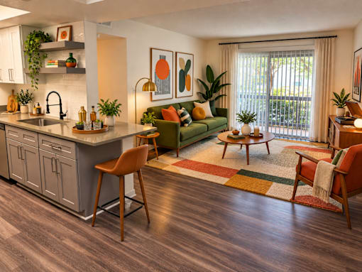 A modern kitchen with a green couch and wooden floors.