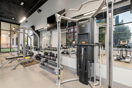 a gym with weights and cardio equipment at aria on the avenue apartments