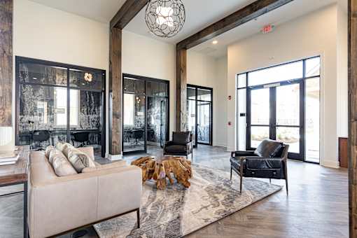 a living room with a couch and chairs and a rug