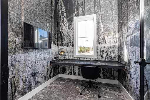 a home office with a desk and a window