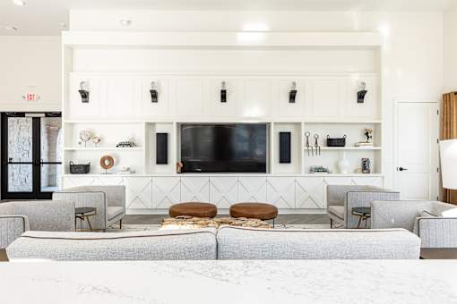 a living room with couches and chairs and a television
