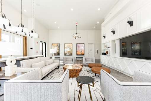 a living room with couches and chairs and a television
