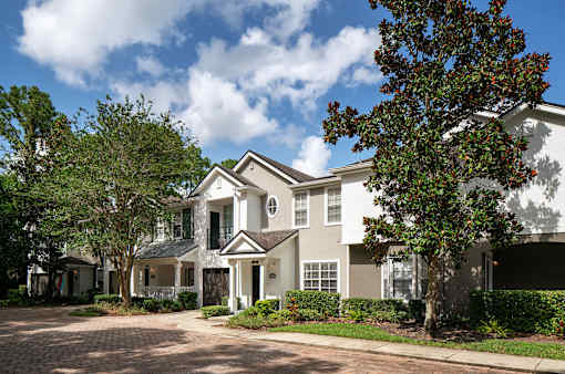 a large white house with trees in front of it