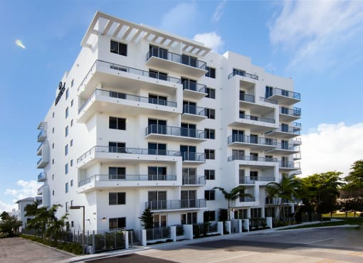 a large white apartment building on a sunny day at Saba Pompano Beach, Pompano Beach, 33062