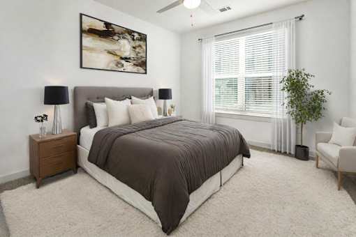 a bedroom with a bed and a large window