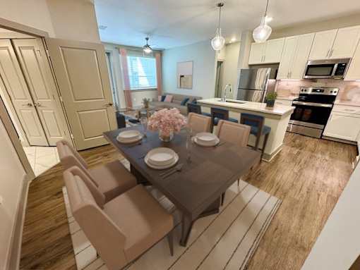 A dining room with a table set for two and chairs surrounding it.