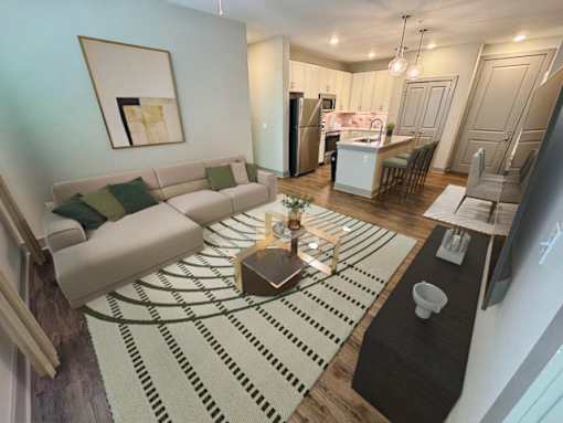 A modern living room with a large couch and a coffee table in the center.