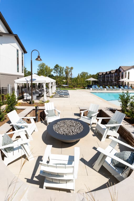 our apartments have an outdoor patio with chairs and a fire pit