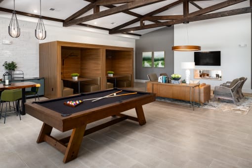 a living room with a pool table in the center of it