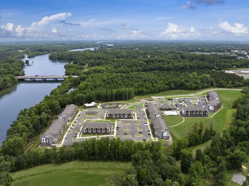 an aerial view of a campus with a body of water