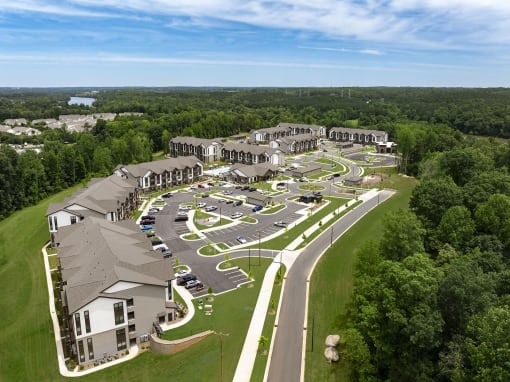 an aerial view of a resort with parking lot and buildings