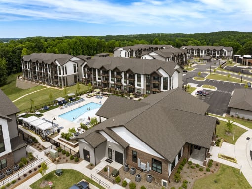 an aerial view of an apartment complex with a swimming pool