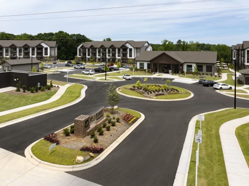 an aerial view of a street with houses and a parking lot