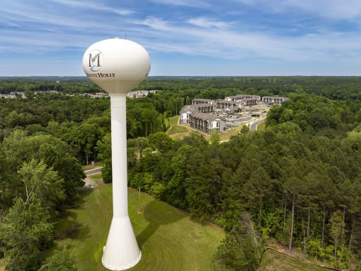 an aerial view of a water tower with buildings in the background