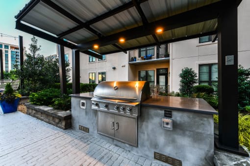 a large outdoor kitchen with stainless steel appliances and a pergola