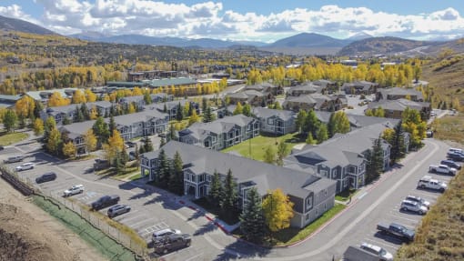 an aerial view of a neighborhood of houses with cars parked in front of them