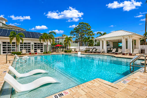 A pool with a white building in the background.