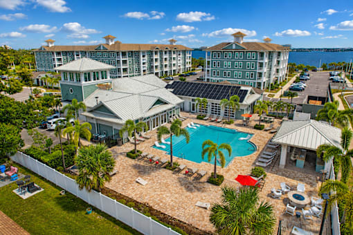 A resort with a pool and palm trees.