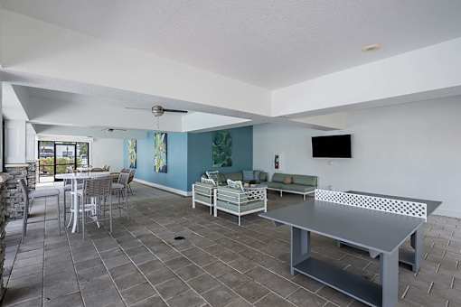 A room with a grey table and chairs.