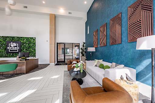 A modern waiting room with a green chair and a green wall with a sign that says