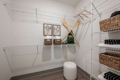A white closet with shelves and baskets.