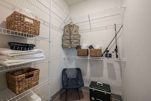 A white closet with shelves and baskets on them.
