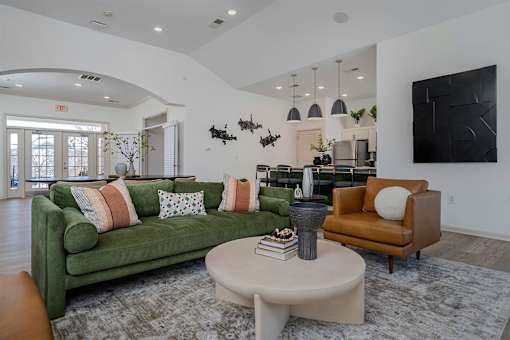 A living room with a green couch and a coffee table.