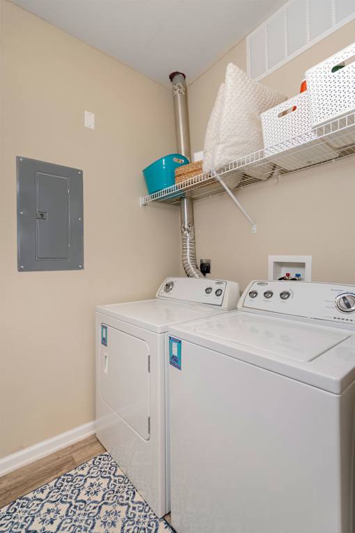 A small laundry room with a washer and dryer.