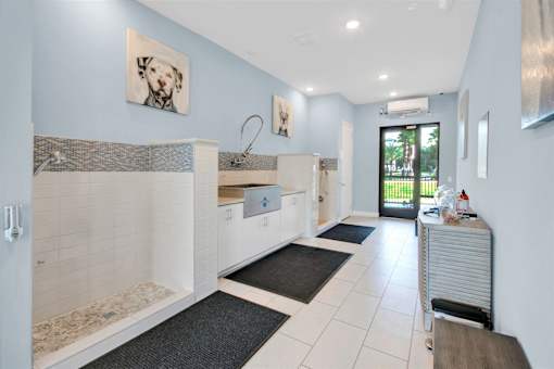 A bathroom with a white tub and a white sink.