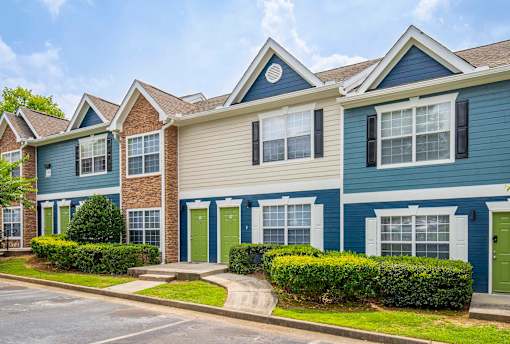 A row of houses with blue and beige siding.