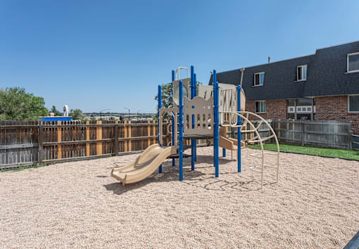 A playground with a slide, swings, and a climbing frame.
