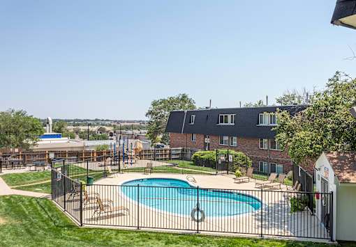 A black fence surrounds a small pool.