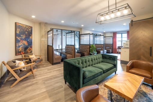 a living room with a green couch and chairs