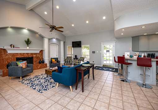 A living room with a fireplace and a blue chair.