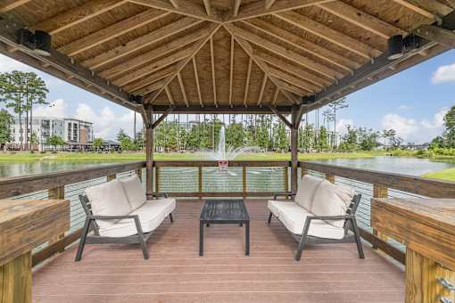 A wooden deck with two chairs and a table.