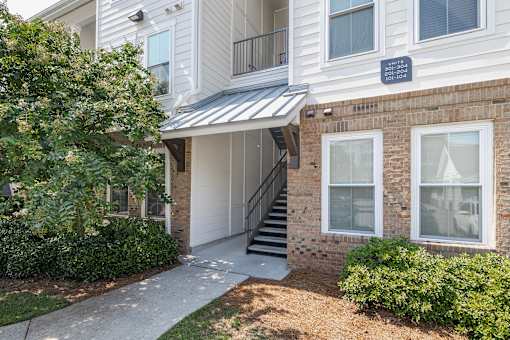 A white building with a sign that says "TO LIVING ROOM" on the side.