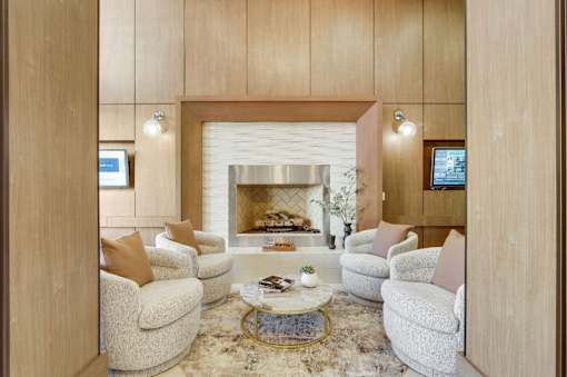 Atlanta, GA Pet-Friendly Luxury Apartments - 1105 Town Brookhaven - Lounge Area with Cozy Seating, Marble Coffee Table, and Fireplace.
