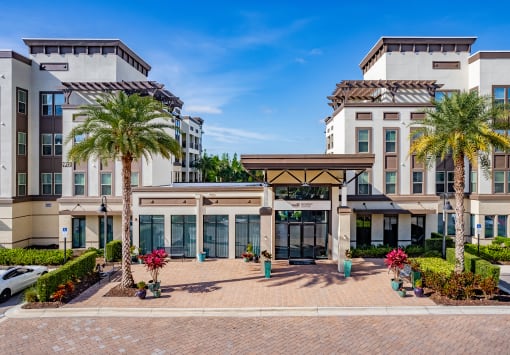 a large building with palm trees in front of it