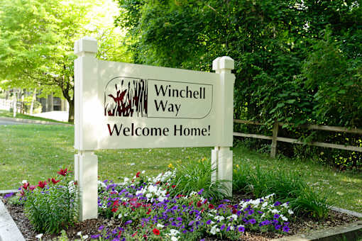 A sign that says Winchell Way Welcome Home