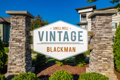 a sign that reads vintage with a building in the background