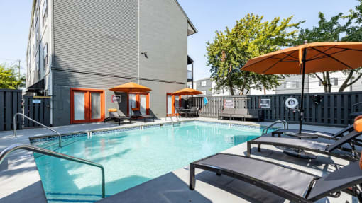 our apartments have a resort style pool with lounge chairs and umbrellas