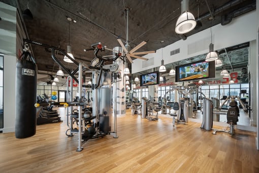 a large fitness room with cardio equipment and flat screen tvs at Altis Grand Central, Tampa Florida