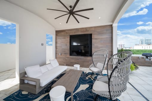 a living room with a couch and chairs in front of a tv at Altis Grand Central, Florida, 33606
