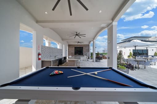 a pool table in a patio area of a home at Altis Grand Central, Florida
