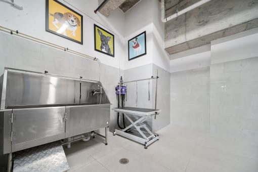a kitchen with a large stainless steel sink and a walk in shower at Altis Grand Central, Tampa, 33606