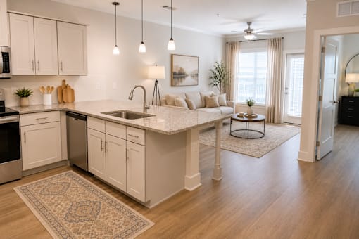 A kitchen with white cabinets and a rug on the floor.